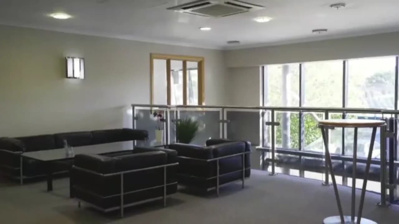 Still @5s - reception lounge, black leather sofas, mezzanine glass balustrade